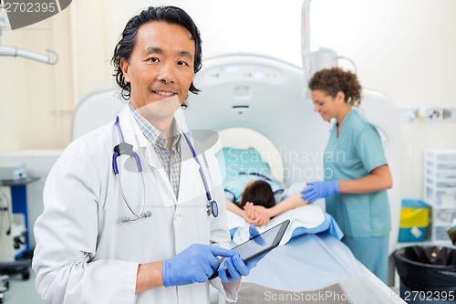 Image of Radiologist Using Digital Tablet During CT Scan
