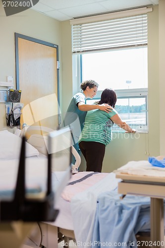 Image of Nurse Consoling Pregnant Woman Having Contraction