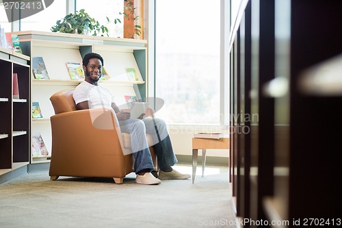 Image of Student Using Digital Tablet In Bookstore