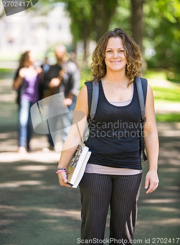 Image of Student With Backpack And Book Standing On Campus