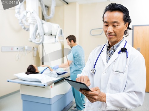 Image of Medical Team With Patient In Examination Room