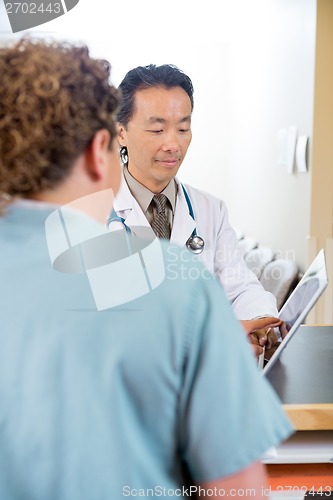 Image of Nurse With Doctor Using Digital Tablet At Reception