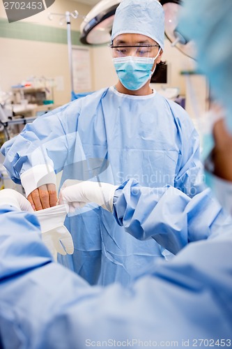 Image of Scrub Nurse Helping Surgeon with Sterile Glove