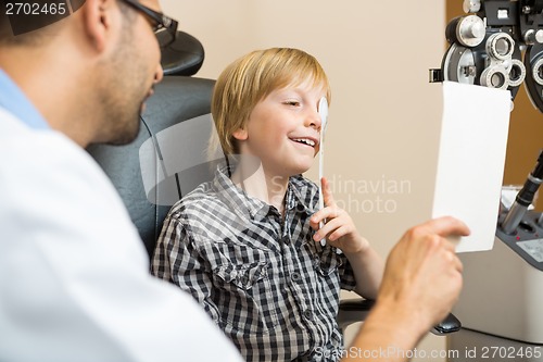 Image of Boy Covering Eye with Occluder