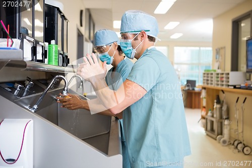 Image of Surgical Staff Scrubbing Hands and Arms