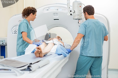 Image of Nurses Preparing Patient For CT Scan