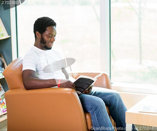 Image of Student Reading Book In Library