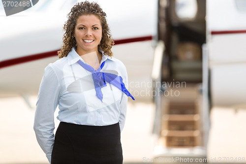 Image of Beautiful Stewardess With Private Jet In Background