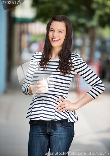 Image of Woman Holding Coffee Cup Outdoors