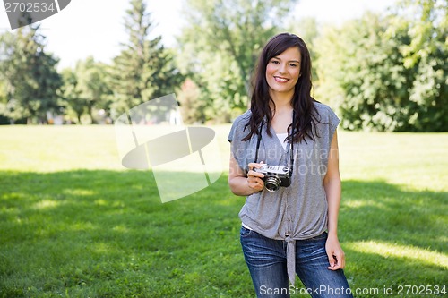 Image of Woman With Digital Camera In Park