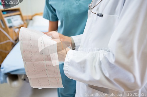 Image of Midsection Of Doctor And Nurse With Fetal Heartbeat Report