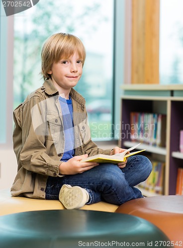 Image of Happy Boy Reading Book In Library