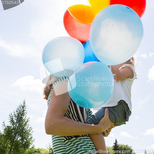 Image of Mother And Daughter With Balloons In Park