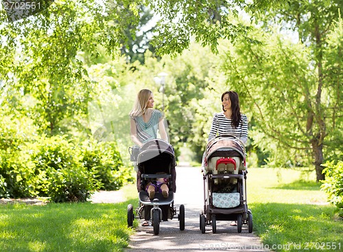 Image of Mothers With Baby Carriages Walking In Park