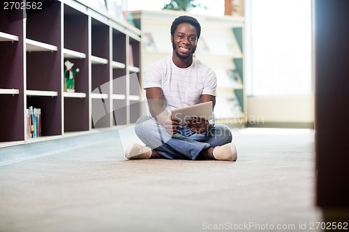 Image of Student With Digital Tablet Sitting In Library