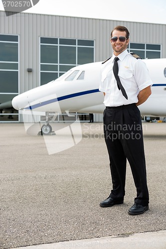 Image of Confident Pilot With Private Jet In Background