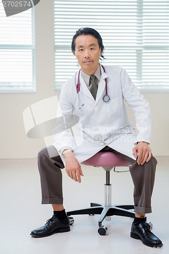 Image of Cancer Specialist Sitting On Chair In Hospital Room