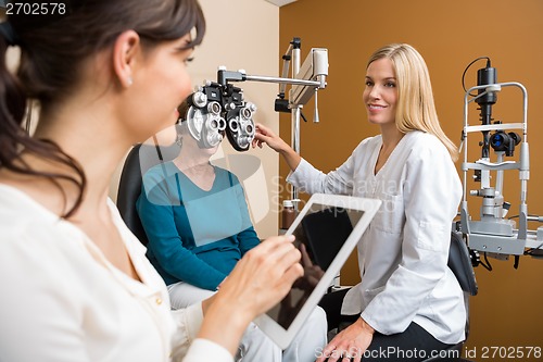 Image of Eyecare Specialist Examining Senior Woman