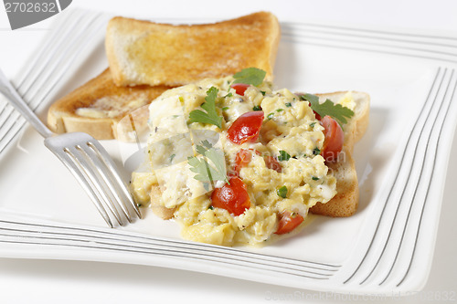 Image of Scrambled egg and tomatoes on toast