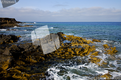 Image of water  in lanzarote  isle foam   stone sky cloud beach  
