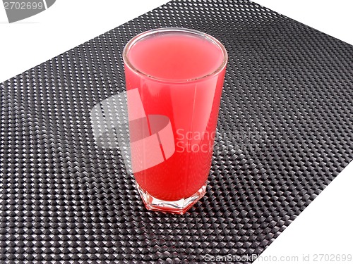 Image of fresh cherry juice in a glass on black background