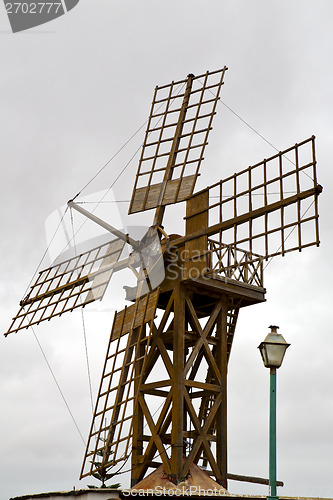 Image of hole windmills in  isle of   spain   the sky 