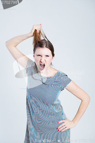 Image of Attractive woman pulling her hair