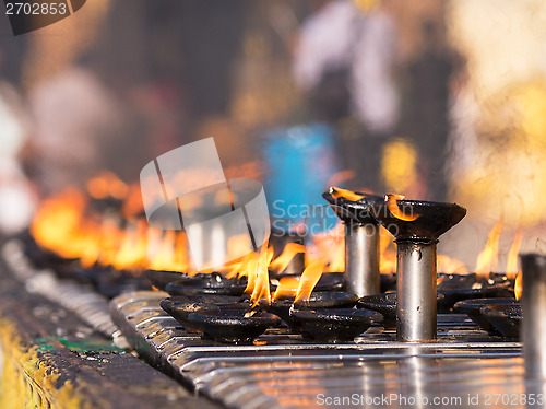 Image of Burning oil lamps at the Shwedagon Pagoda in Yangon