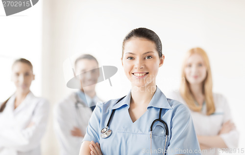 Image of female doctor in front of medical group