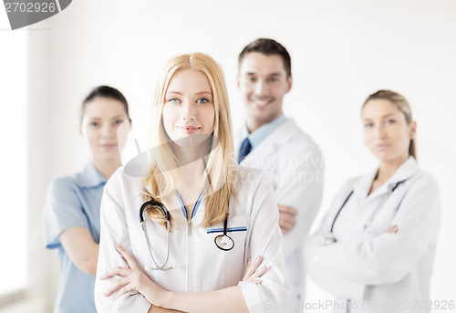 Image of female doctor in front of medical group