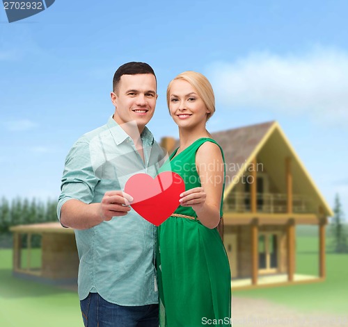 Image of smiling couple holding big red heart