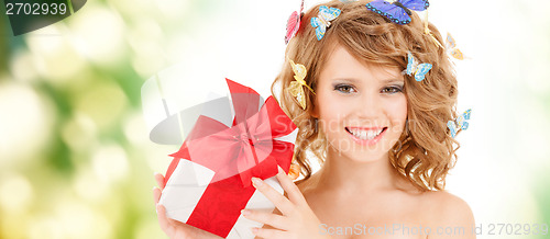 Image of teenager with butterflies in hair showing present