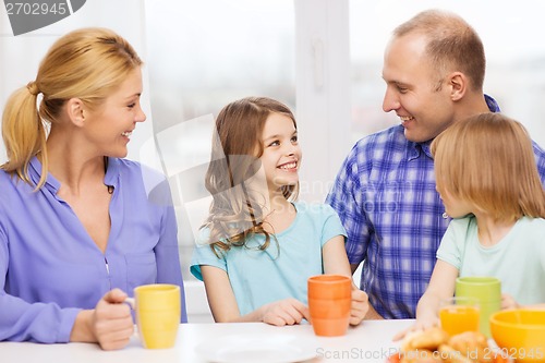 Image of happy family with two kids with having breakfast