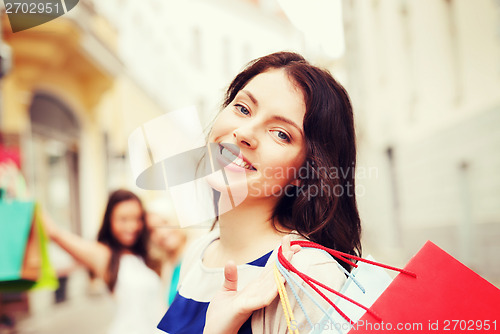 Image of girls with shopping bags in city