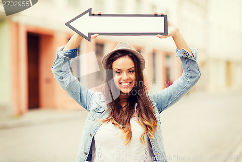 Image of girl showing direction with arrow in the city