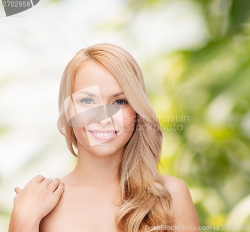 Image of face and shoulders of happy woman with long hair