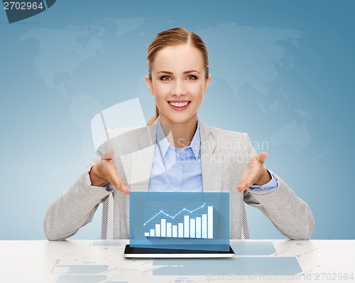 Image of smiling businesswoman with tablet pc