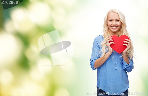 Image of smiling woman with red heart