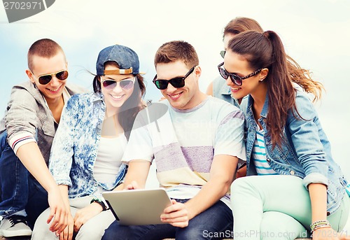 Image of group of teenagers looking at tablet pc
