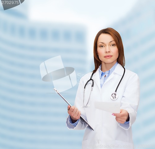 Image of calm female doctor with clipboard