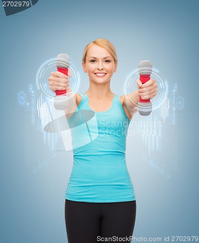 Image of young sporty woman with light dumbbells