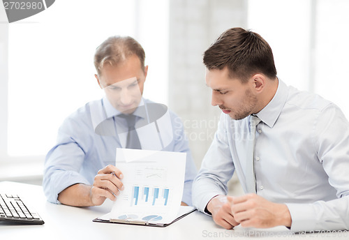 Image of businessmen with notebook on meeting