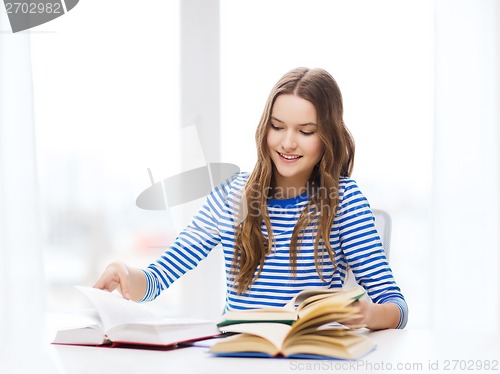 Image of happy smiling student girl with books