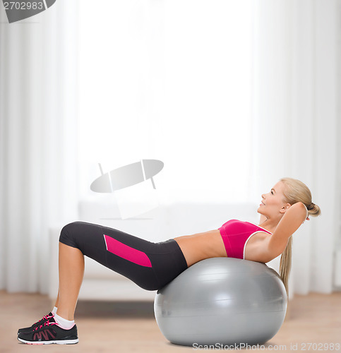 Image of smiling woman with fitness ball