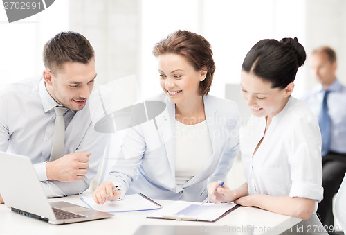 Image of business team discussing something in office