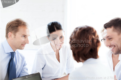 Image of businesswoman with team on meeting in office