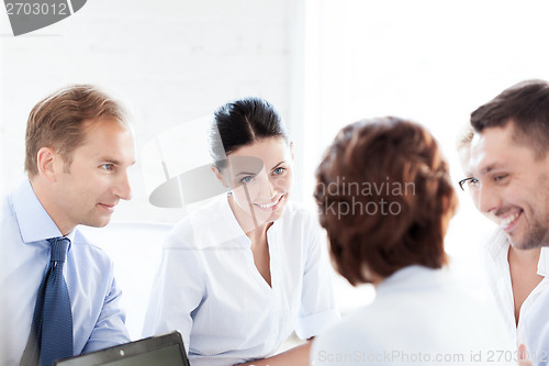 Image of businesswoman with team on meeting in office