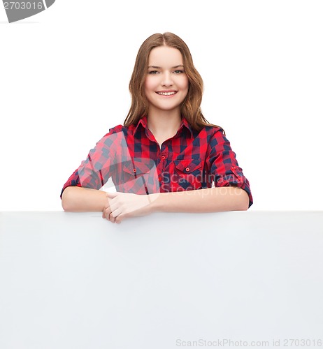 Image of smiling young teenage girl with white blank board