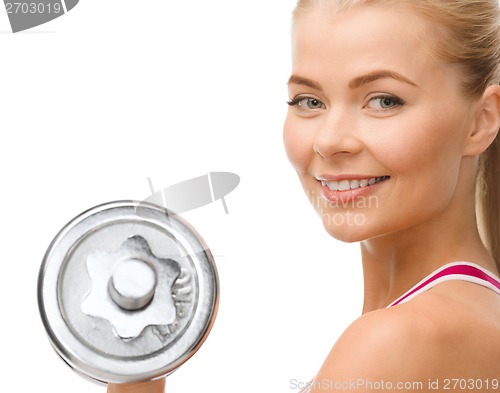 Image of smiling woman with heavy steel dumbbell