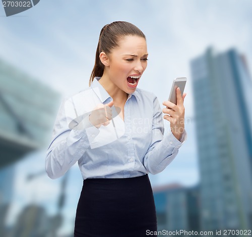 Image of screaming businesswoman with smartphone